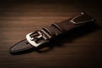 Dark brown full-grain leather watch strap — cinematic studio shot