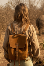 Woman wearing Zunera leather backpack at golden hour African savanna