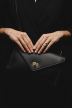 Black leather crossbody bag - hands detail close-up