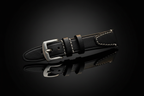 Black full-grain leather watch strap — cinematic studio shot