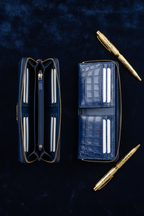Overhead flat lay - wallets open and gold pens