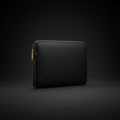 Matte black full-grain leather laptop sleeve on dark background