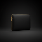 Matte black full-grain leather laptop sleeve on dark background